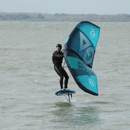 single man wingsurfing on the open water
